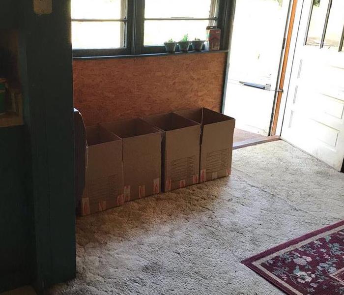 Pack-out boxes lining the walls of affected home waiting for contents