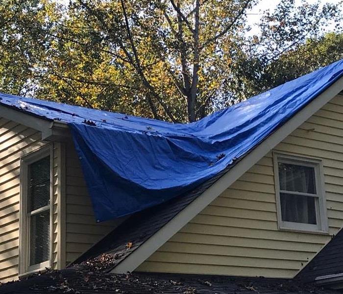 Roof tarped to prevent further water damages