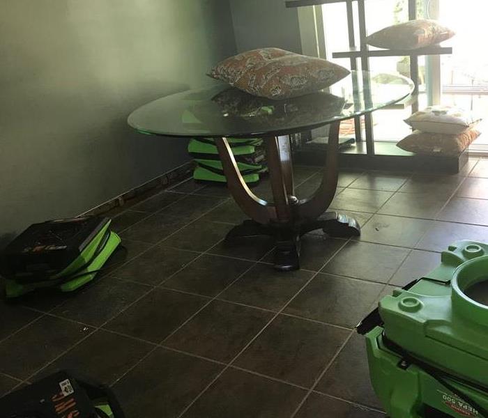 SERVPRO Green drying equipment placed in dining room